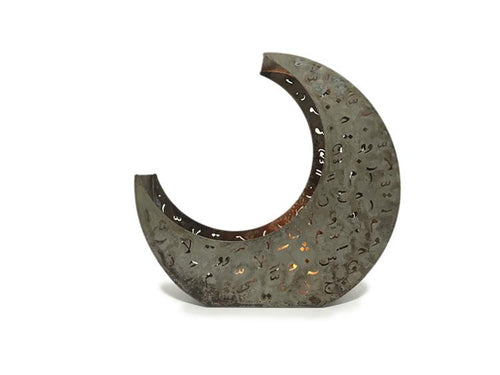 crescent shaped candle holder in rusted metal with laser cut design of Arabic letters & diacritics