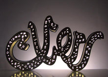 Load image into Gallery viewer, 1m long Ramadan decoration in mirror gold stainless steel, 3D free standing light sign of the term "Ramadan" in Arabic calligraphy. light on in dark view. front view