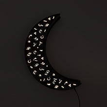 Load image into Gallery viewer, Crescent wall light ramadan decoration with arabic diacritics. light on in darkness.