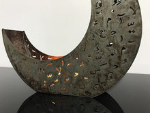 Load image into Gallery viewer, crescent shaped candle holder in rusted metal with laser cut design of Arabic letters &amp; diacritics
