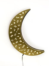 Load image into Gallery viewer, Crescent ramadan wall light in gold brushed stainless steel with laser cut design of Arabic diacretics. 
