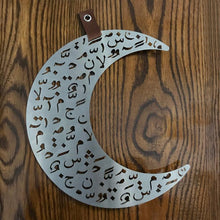 Load image into Gallery viewer, crescent ramadan door decoration in brushed stainless steel with laser cut design of Arabic letters &amp; diacritics
