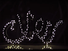 Load image into Gallery viewer, 1m long Ramadan decoration in brushed stainless steel, 3D free standing light sign of the term &quot;Ramadan&quot; in Arabic calligraphy. light on in dark view
